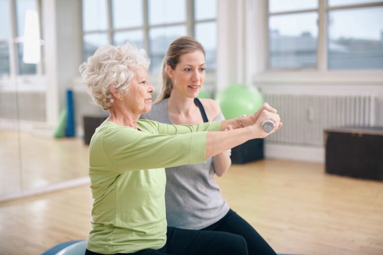 Elderly woman in fitness class